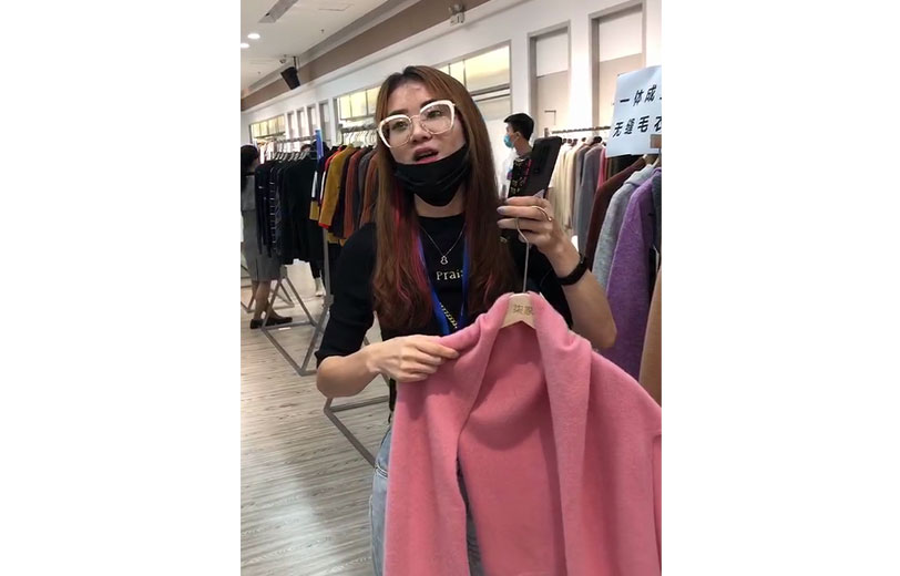 东莞市文乐服装有限公司为国内外知名品牌贴牌加工18年，受疫情影响，今年开始转型做国内市场。在对接会专区，该公司展示的一体成型无缝毛衣受到采购商的认可。